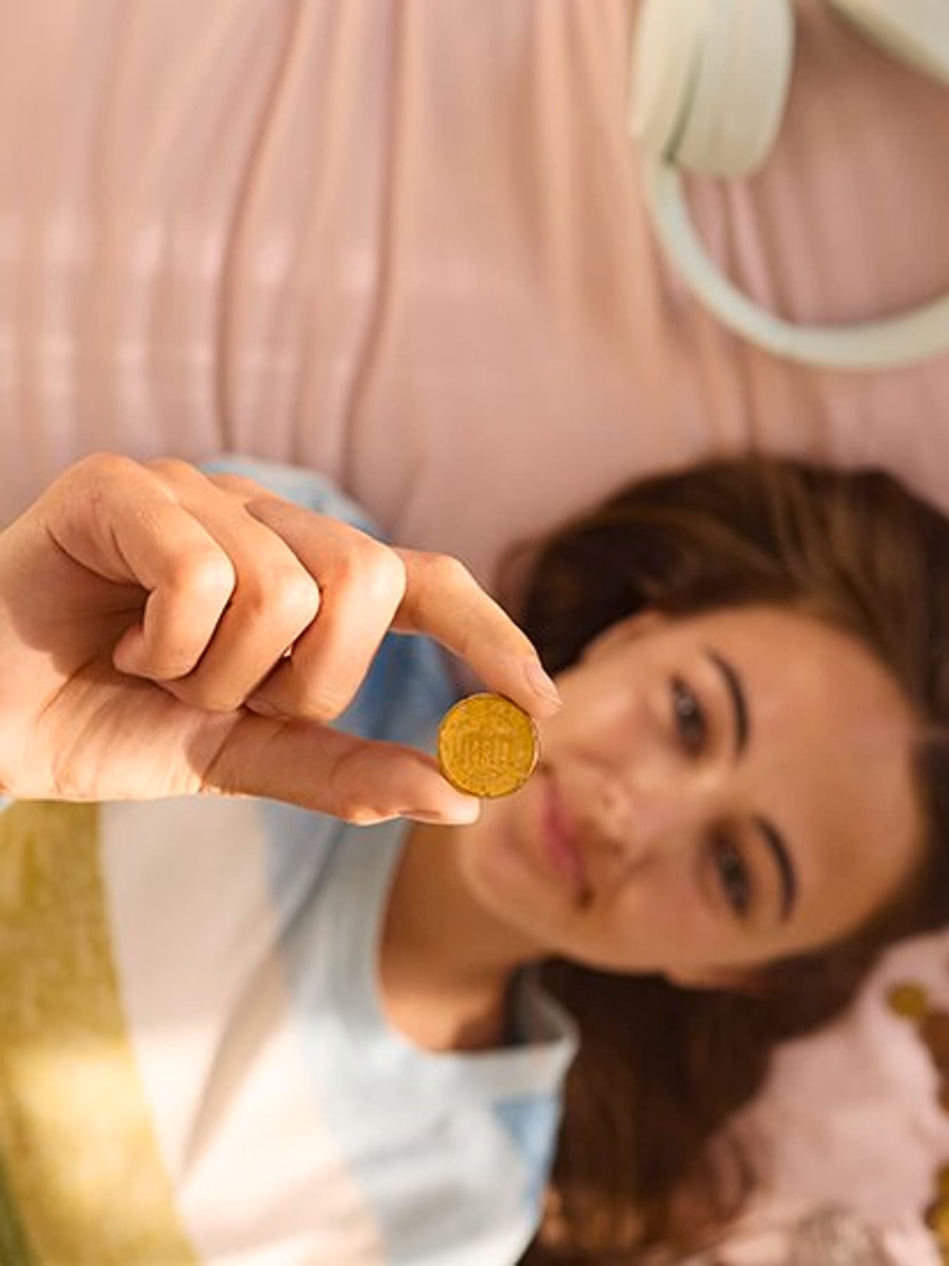 Femme tenant une pièce de monnaie | Vaillant