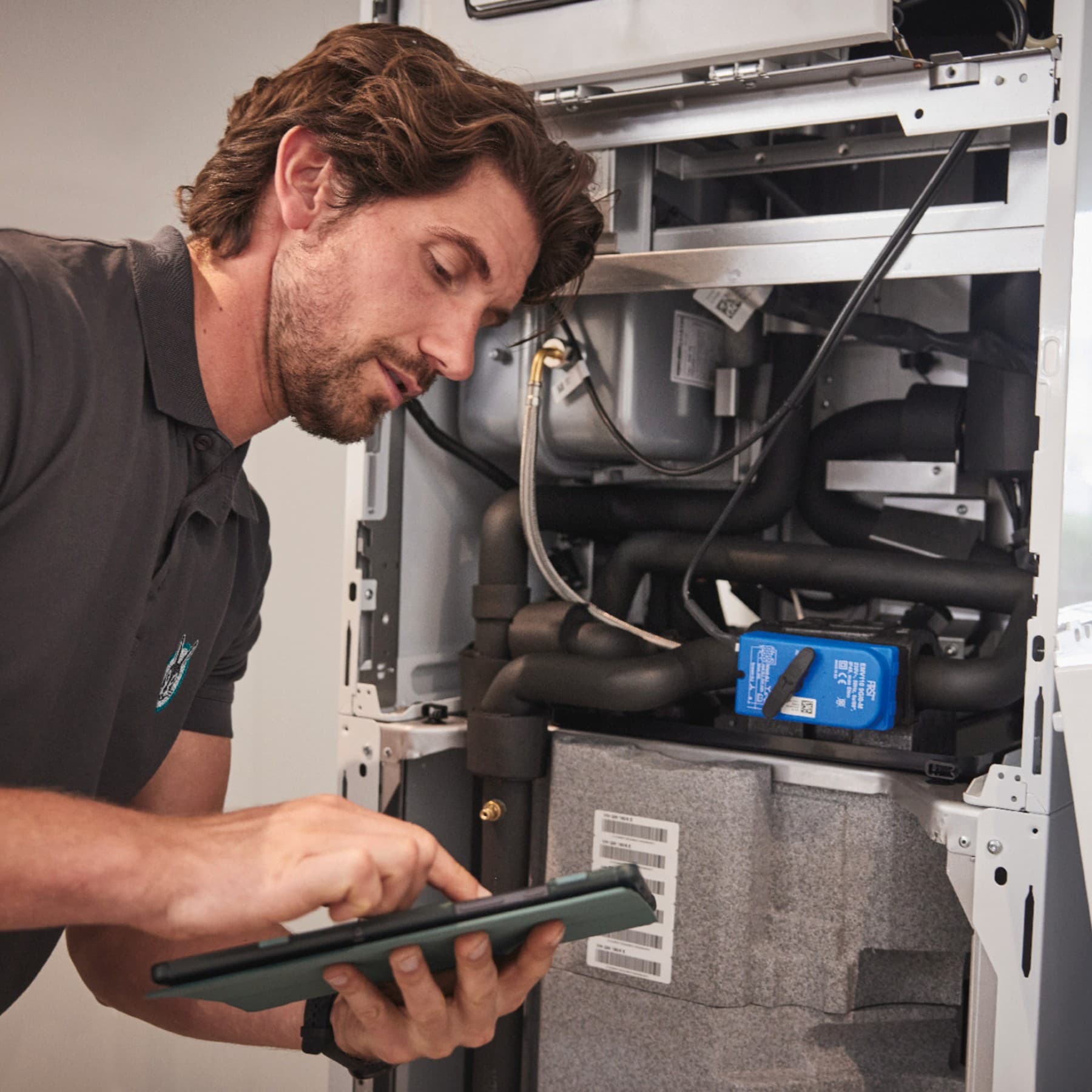 Homme travaillant sur un système de chauffage | Vaillant