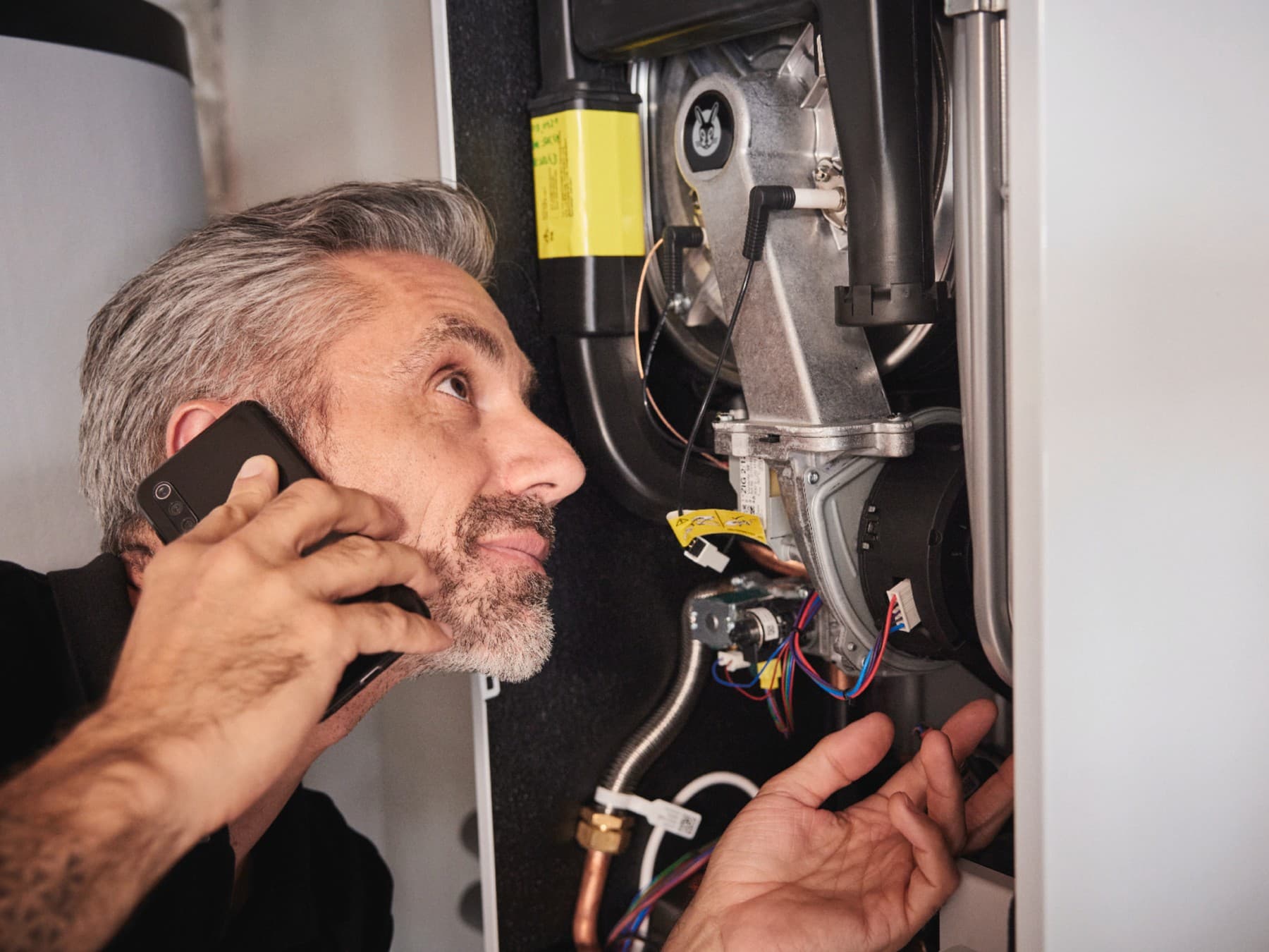 Un réparateur cherche la panne d'une chaudière pour une réparation | Vaillant